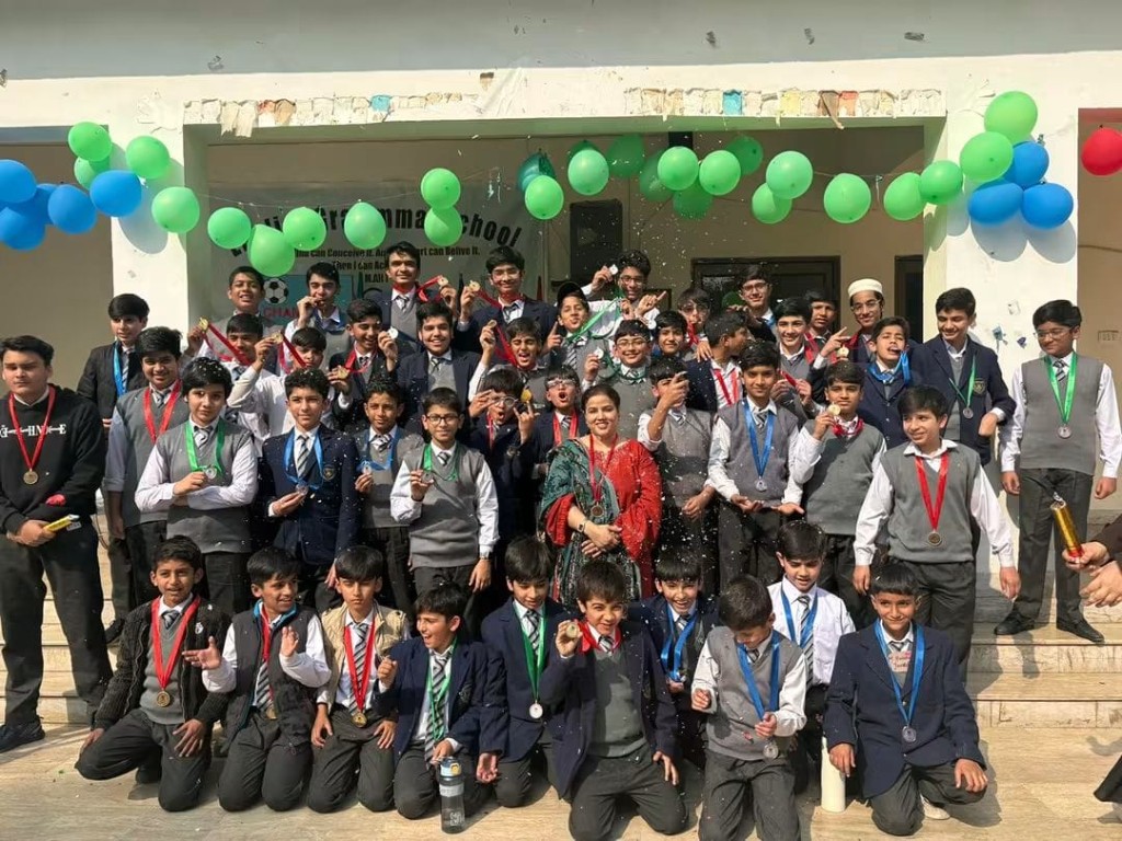 EGS students celebrating with medals at an awards ceremony